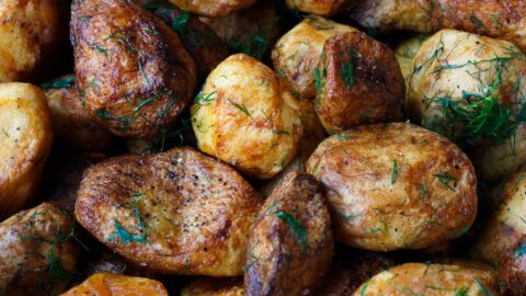 baked potatoes with rosemary garnish