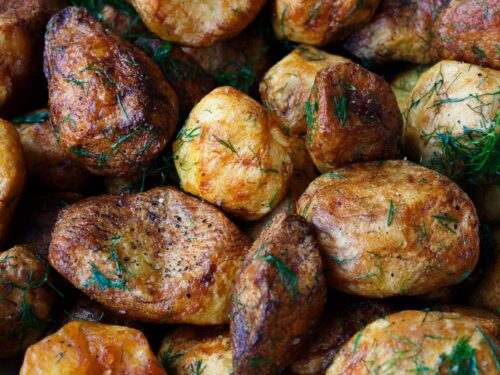 baked potatoes with rosemary garnish