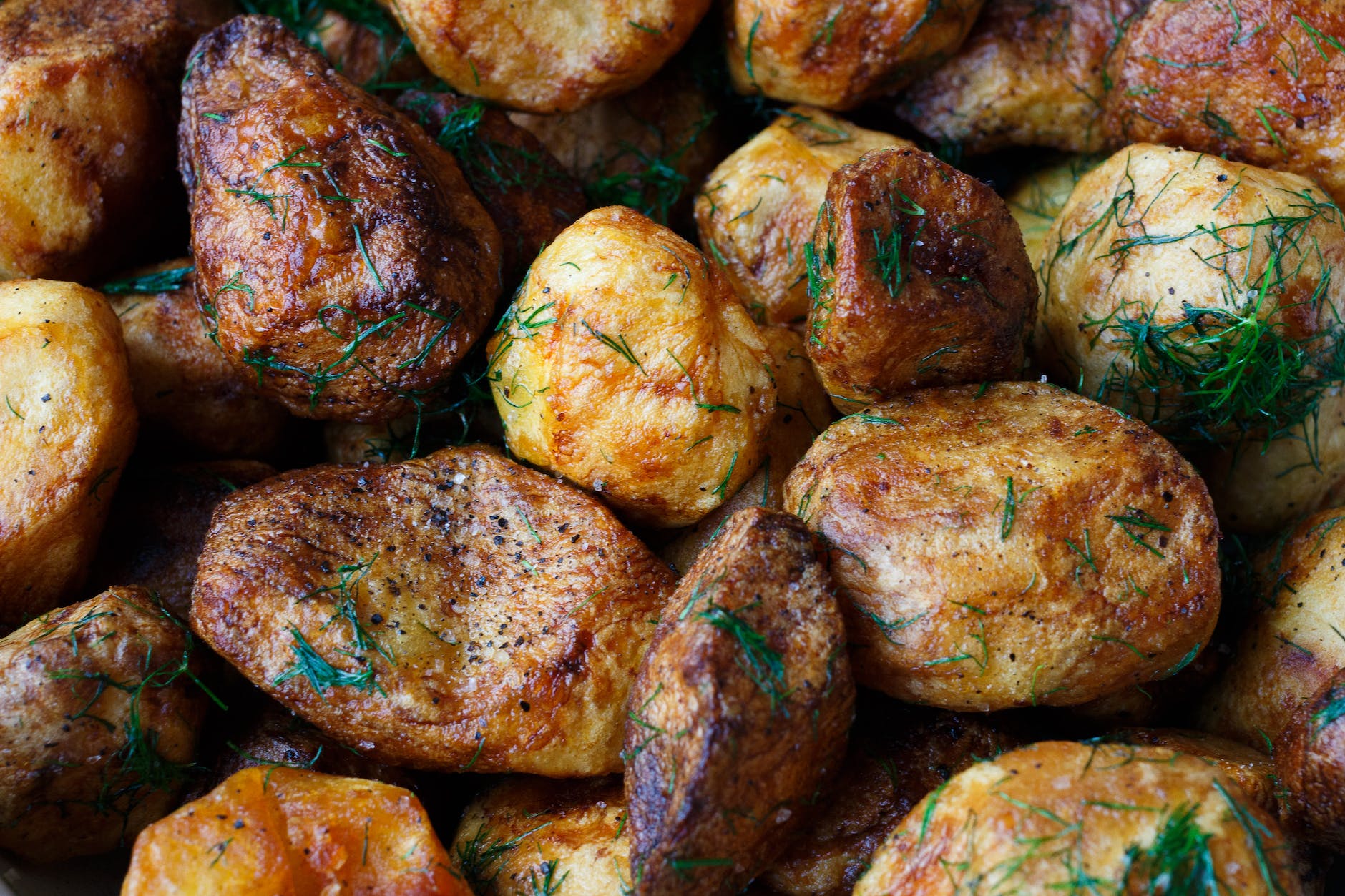 baked potatoes with rosemary garnish