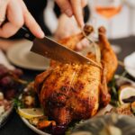 cutting roasted chicken in close up