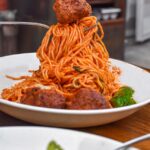 spaghetti with meatballs on ceramic plate