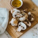 sliced mushrooms on brown wooden chopping board