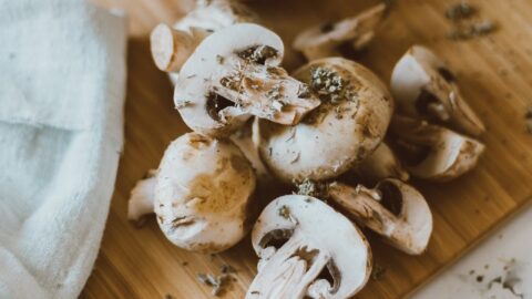 sliced mushrooms on brown wooden chopping board