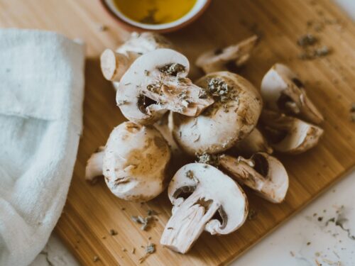 sliced mushrooms on brown wooden chopping board