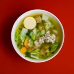 stew with meat and vegetables placed in white ceramic bowl