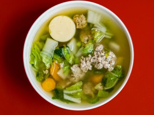 stew with meat and vegetables placed in white ceramic bowl