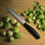 knife with green brussels sprouts