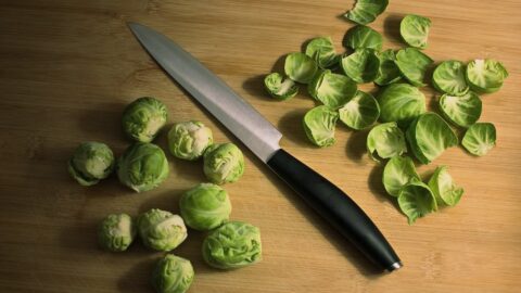 knife with green brussels sprouts