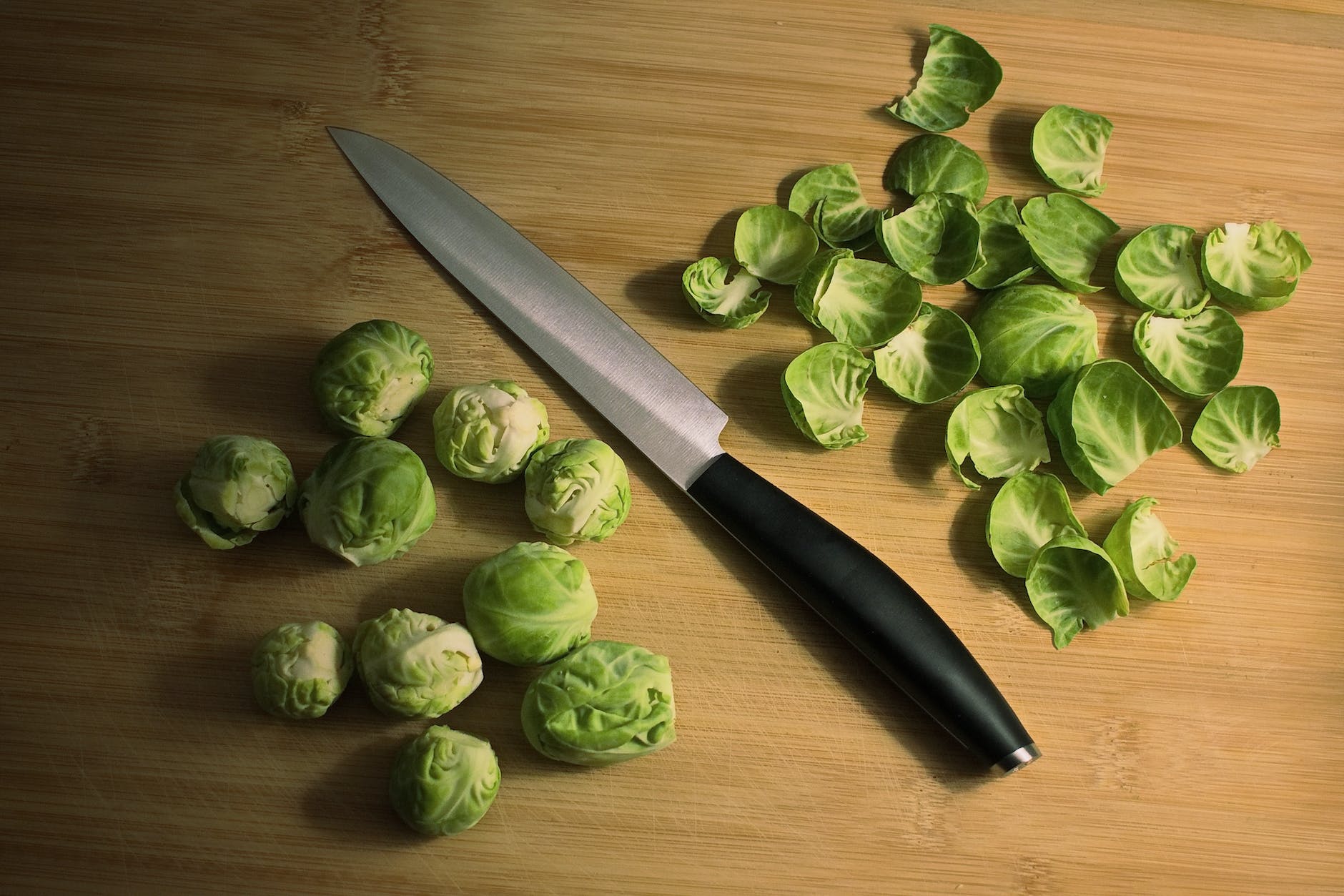 knife with green brussels sprouts